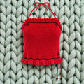 Vista completa top crochet halter rojo con volantes sobre fondo de lana verde menta — LIA.G